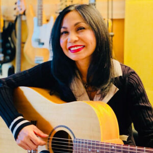 Nani playing guitar in the recording studio